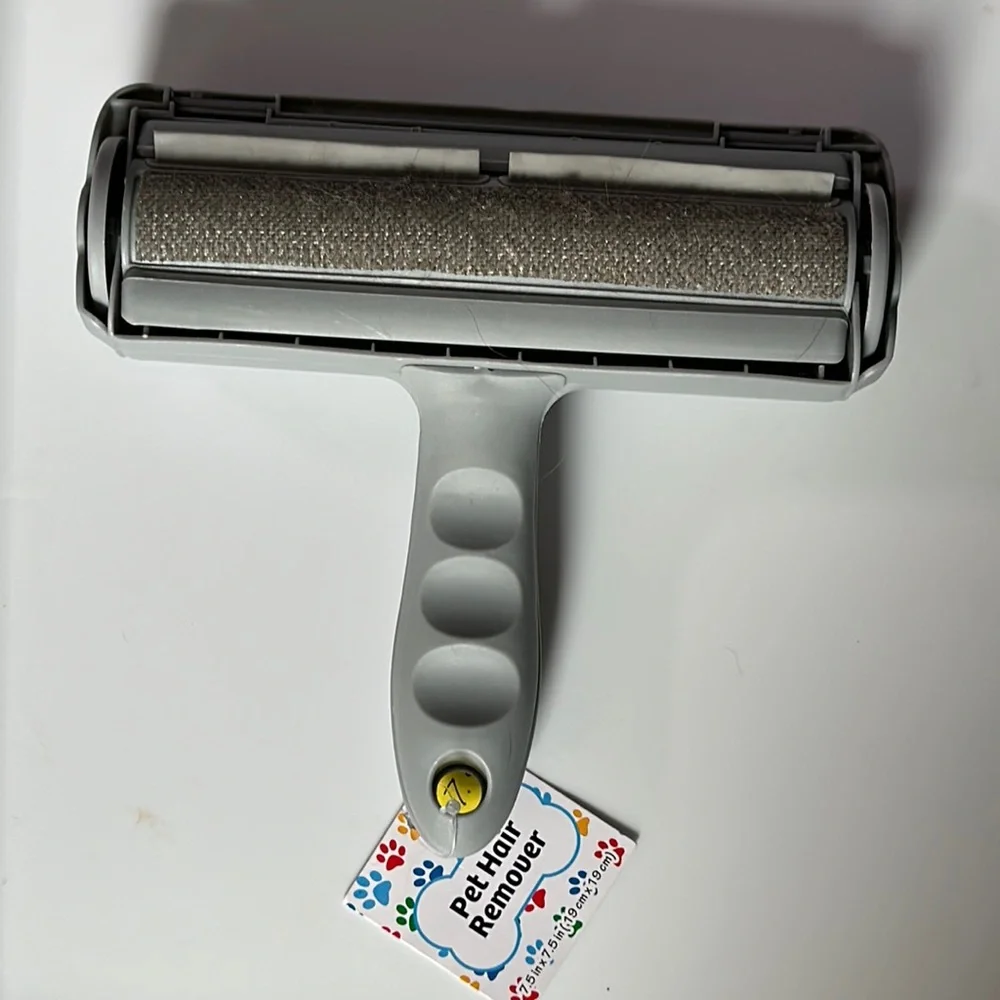 NWT pet hair remover roll the brush along any surface with pet hair and voila